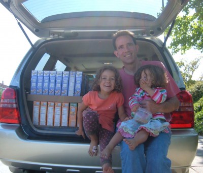 Helpers loading car for food bank