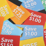 Cutting coupons in different colors, and price ranges from free to a few dollars