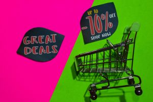 Great Deals and Up To -70% Off Shop Now Text and Shopping cart. Discount and promotion business concept on colorful background