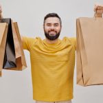 man holding shopping bags