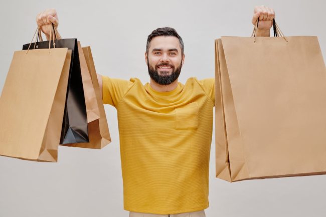 man holding shopping bags