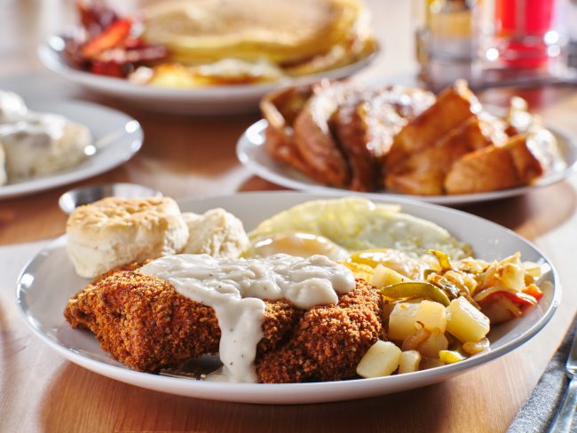 country fried steak with sunny side up eggs and biscuits regional groceries