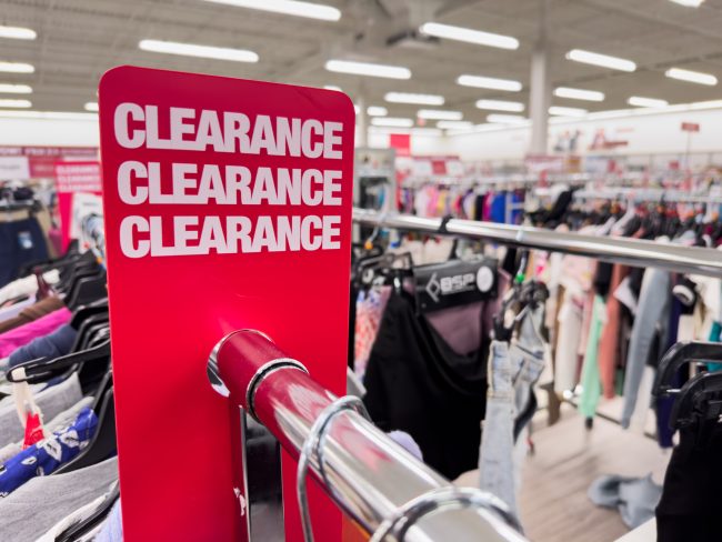 Red clearance sales sign at department store overpriced items that end up in the clearance bin