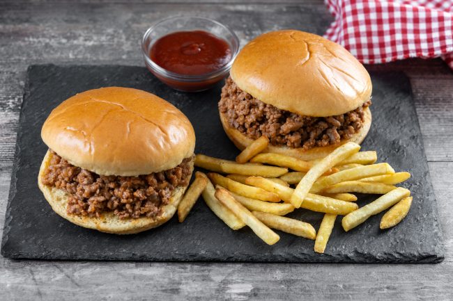 Traditional Sloppy Joe’s sandwich on wooden table nostalgic foods