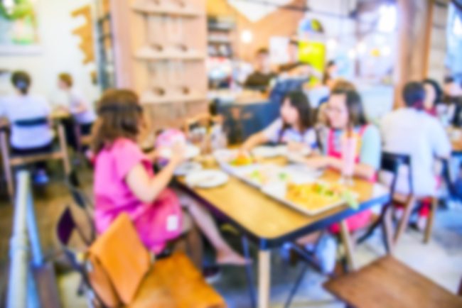 Blurred Customer at restaurant blur background with bokeh, Blurr cafeteria foods from the '80s
