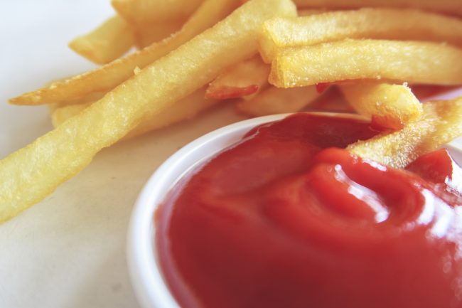 Close up French fries and tomato sauce condiments that have changed formulas