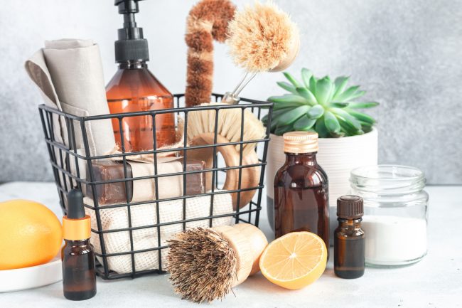 Wooden bamboo brushes, baking soda, lemon, essential oils, vinegar. Zero waste eco friendly cleaning concept. Copy space for your text personal care items