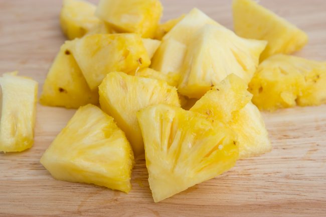 Pineapple slices on the wooden pre-cut produce