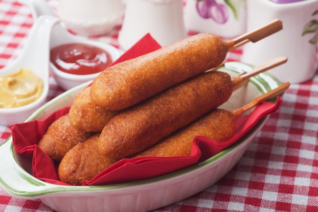 Corn dog with ketchup and mustard American foods that shock Europeans