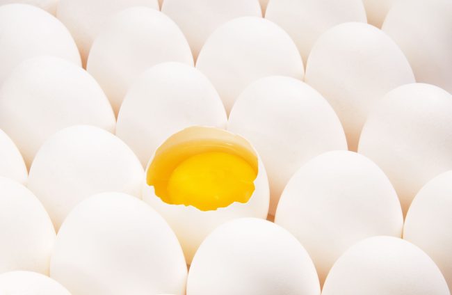 A broken egg in a number of eggs Store-Brand Eggs