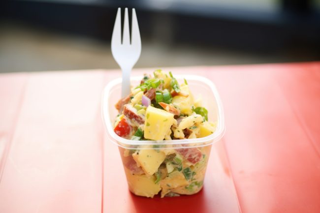 deli potato salad in to-go container with plastic fork on top Frozen Fakery: 7 “Fresh” Meals That Were Made Months Ago