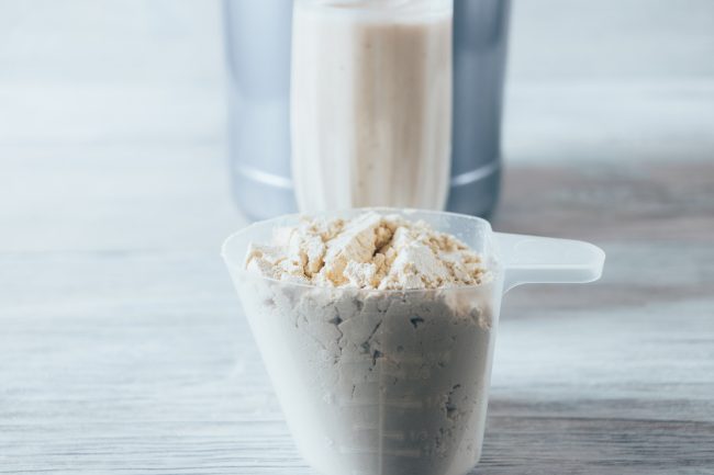 Close-up scoop with serving of dry protein powder overpriced protein shakes