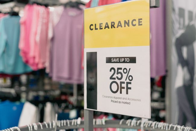 Clearance sign for 25 percent off with blurry modern women cloth hide clearance