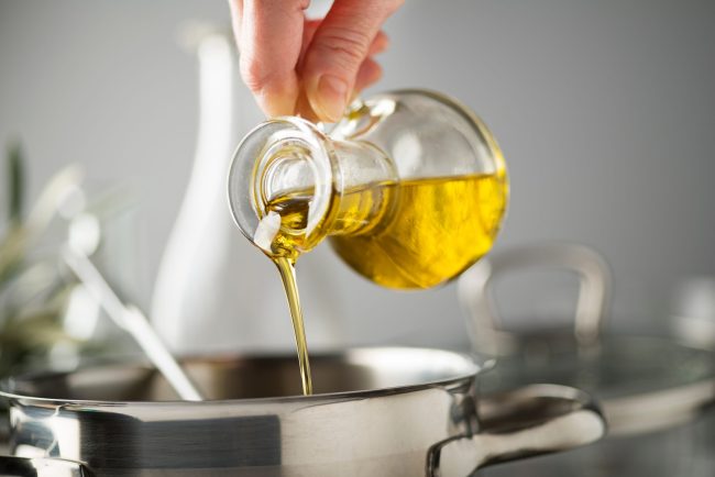 Cooking,Meal,In,A,Pot.,Bottle,Of,Extra,Virgin,Oil Why No One Buys the Top Shelf Olive Oil (But Everyone Should)