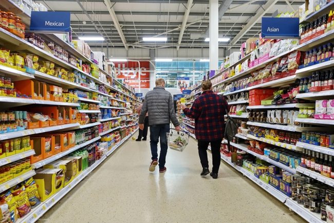 Shoppers,Browse,An,Aisle,In,A,Tesco,Supermarket,On,April grocery store