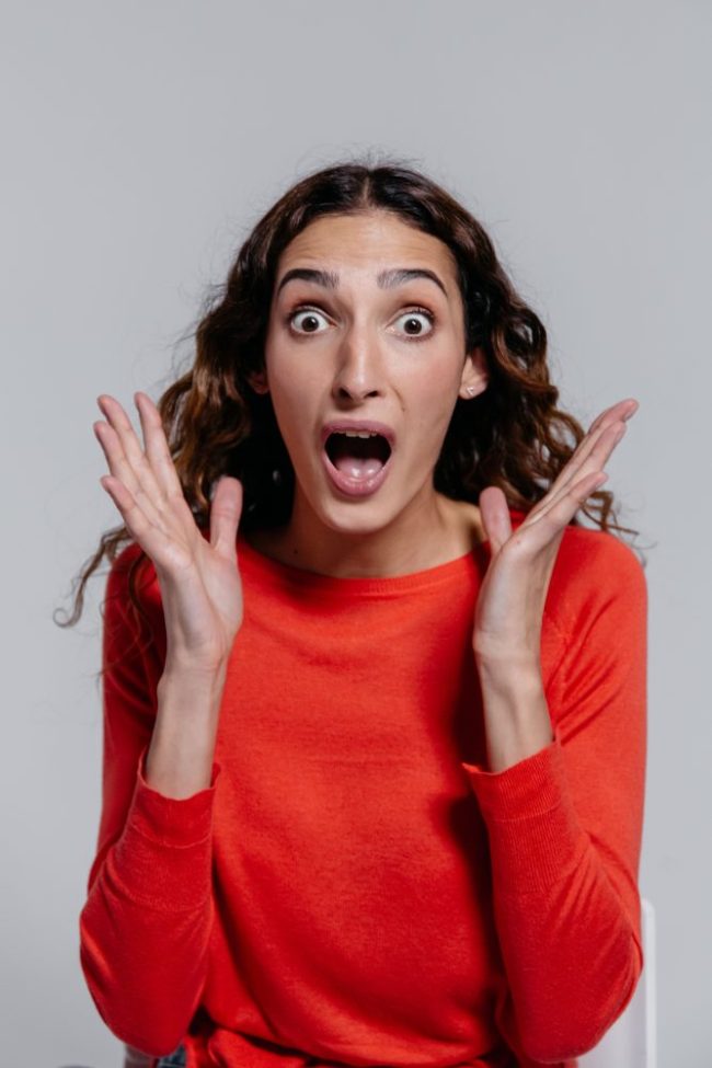 A woman with a surprised expression holding her hands up. 6 SNAP Online Grocery Rules That Still Surprise New Shoppers