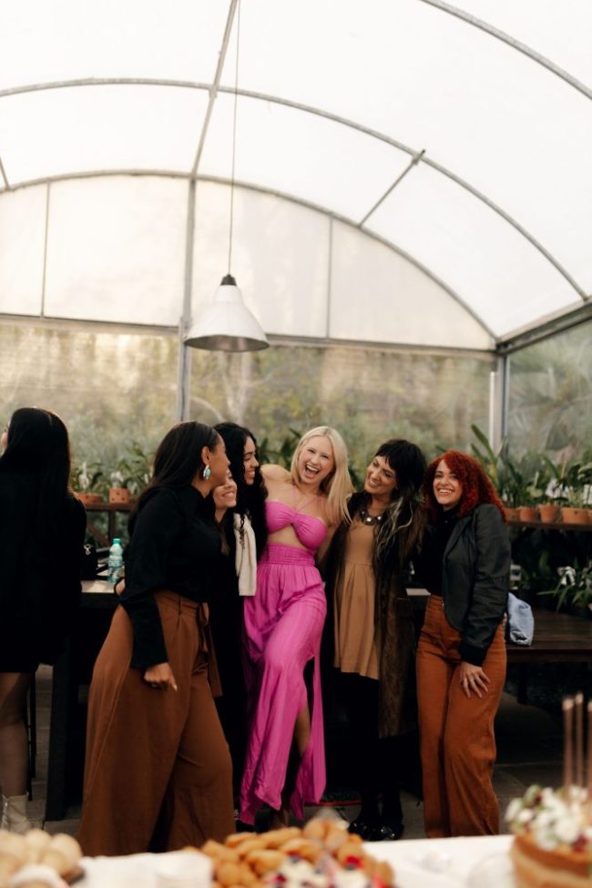 A group of women smiling and laughing together. Women Are Quietly Building 'Emergency Grocery Plans' as Food Prices Keep Rising