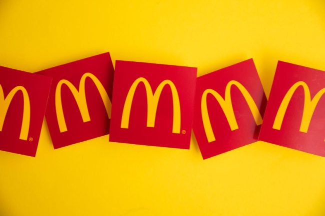 Red McDonald’s golden arches logos lined up on a yellow background. 12 Customer Complaints McDonald's Can't Seem to Escape