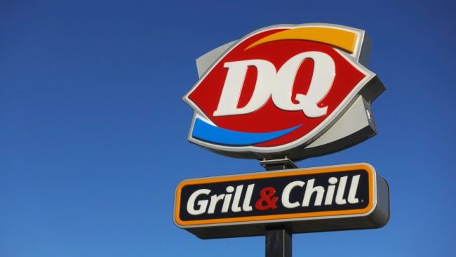 The illuminated outdoor sign for a Dairy Queen Grill & Chill restaurant against a clear blue sky. Dairy Queen Has a $6.99 Chicken Strip Meal — Here’s Everything You Get
