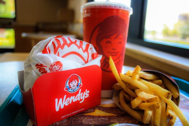 A Wendy’s meal tray featuring a burger in a red box, fries, and a branded drink cup. McDonald’s, Burger King or Wendy’s: Who Gives You the Most Food for $10?