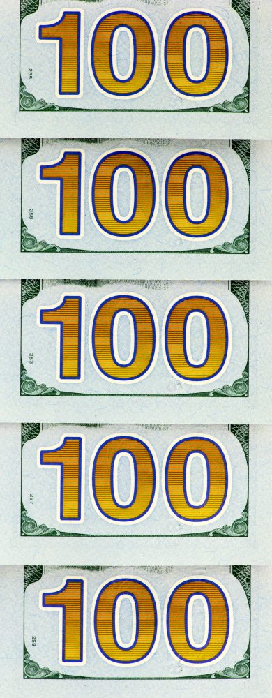 A repeating vertical pattern of the number 100 printed on United States currency. The Grocery Shopping Habit That Makes a $100 Budget Disappear Faster