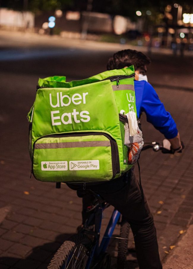 Bicycle Food Delivery Courier on City Street Uber Eats Deals That Look Good Until You Check the Final Total