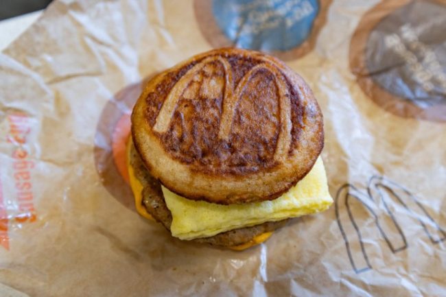 A McDonald’s breakfast sandwich featuring a sausage patty and egg between pancake buns. 10 Fast-Food Items You Should Never Order Without Checking the App First