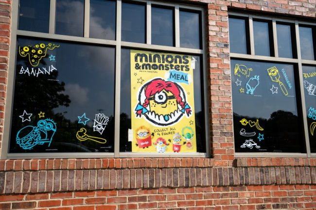 Fast-food restaurant exterior with promotional window decals for kids’ meals. 8 Fast-Food Kids’ Meals That Can Be a Better Deal Than Ordering à la Carte